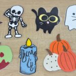 8 spooky scavenger hunt items. A bat, a skeleton, a black cat, a ghost, a poison apple, a melting wax candle, three pumpkins together, and a dog in costume.