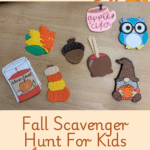 Image of fall scavenger hunt items - candle, leaves, pumpkins, acorn, caramel apple, apple cider mug, gnome, and owl. Text below image reads “Fall Scavenger Hunt for Kids”.
